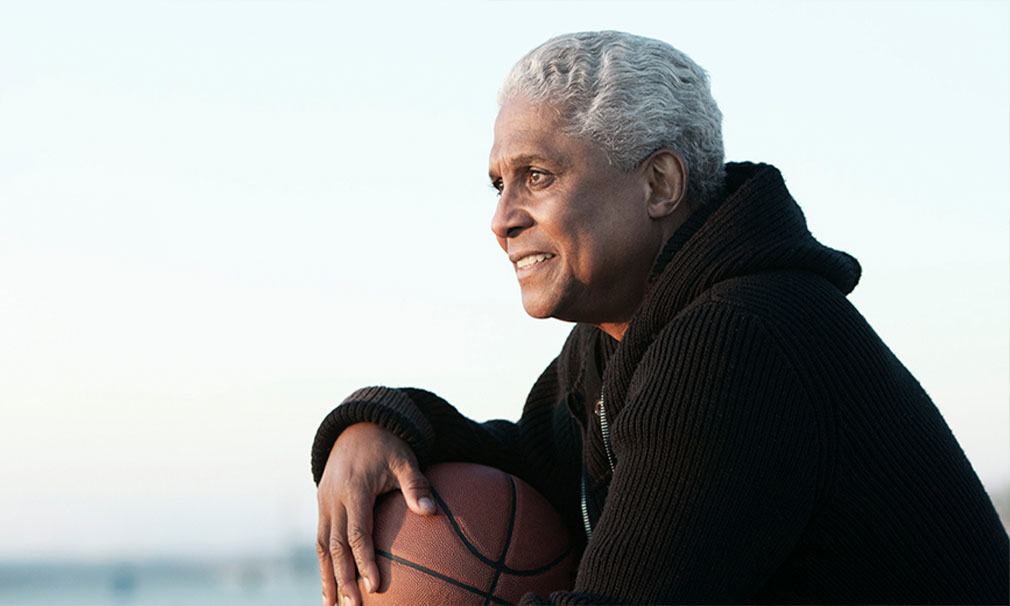 Individual wearing a black shirt and holding a basketball.